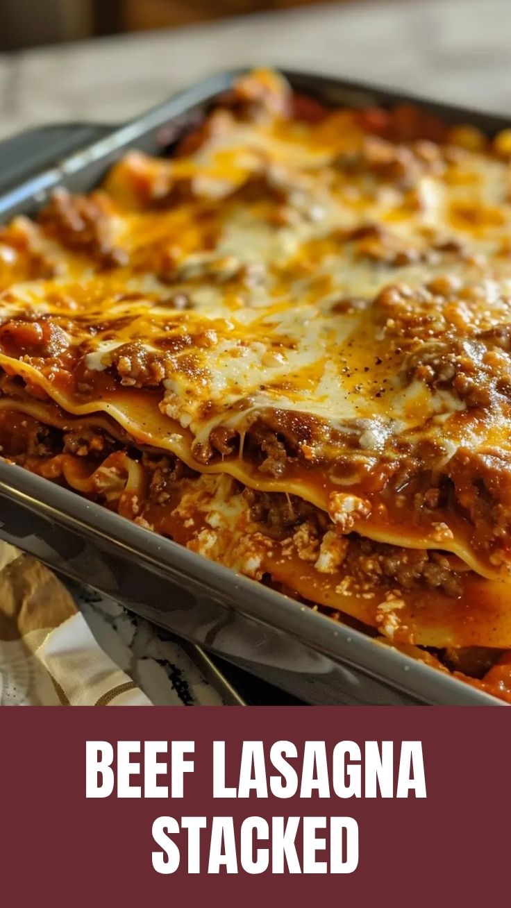 A bubbling dish of savory beef lasagna with a golden cheesy top.