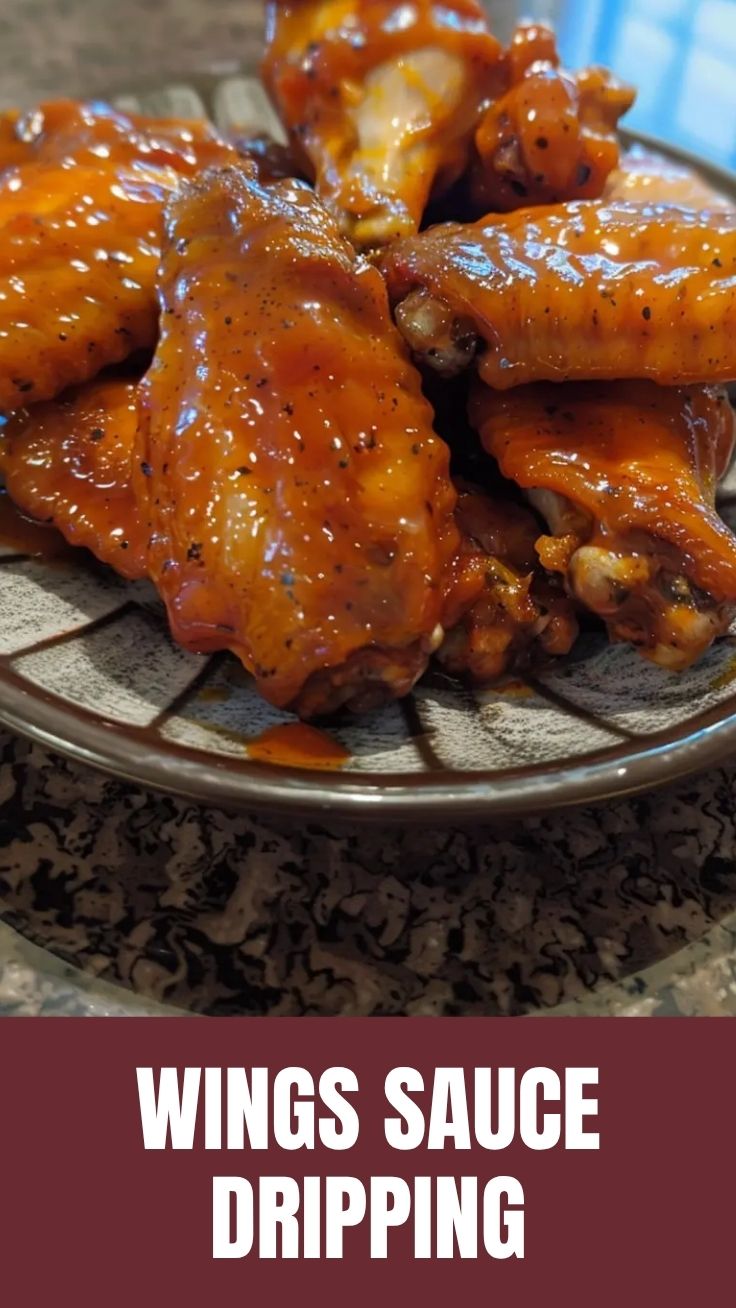 A close-up shot of several buffalo wings coated in a vibrant red sauce, ready to be served.