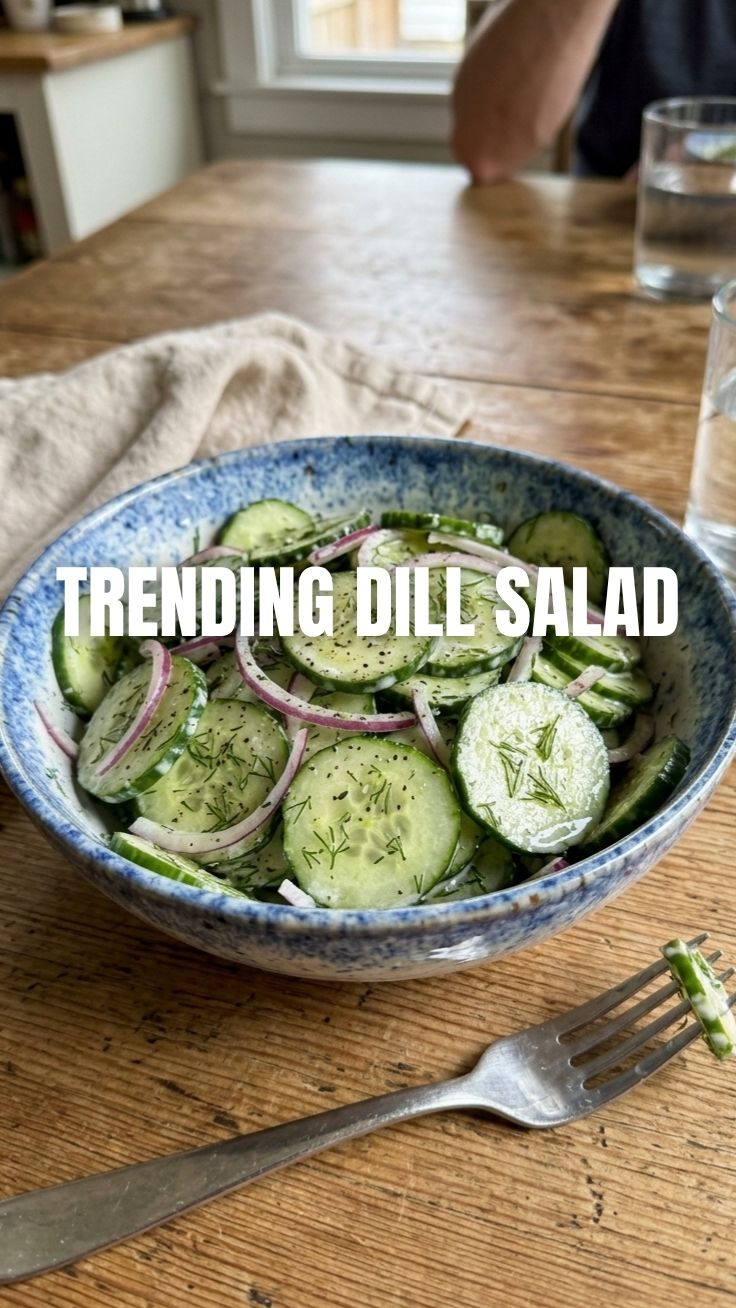 A refreshing cucumber dill salad in a white bowl with fresh ingredients.