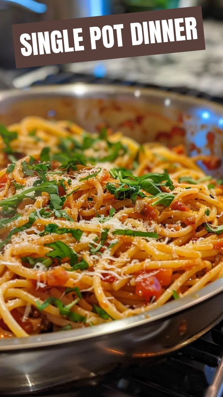 A steaming bowl of one pot pasta with fresh herbs, ready to serve.