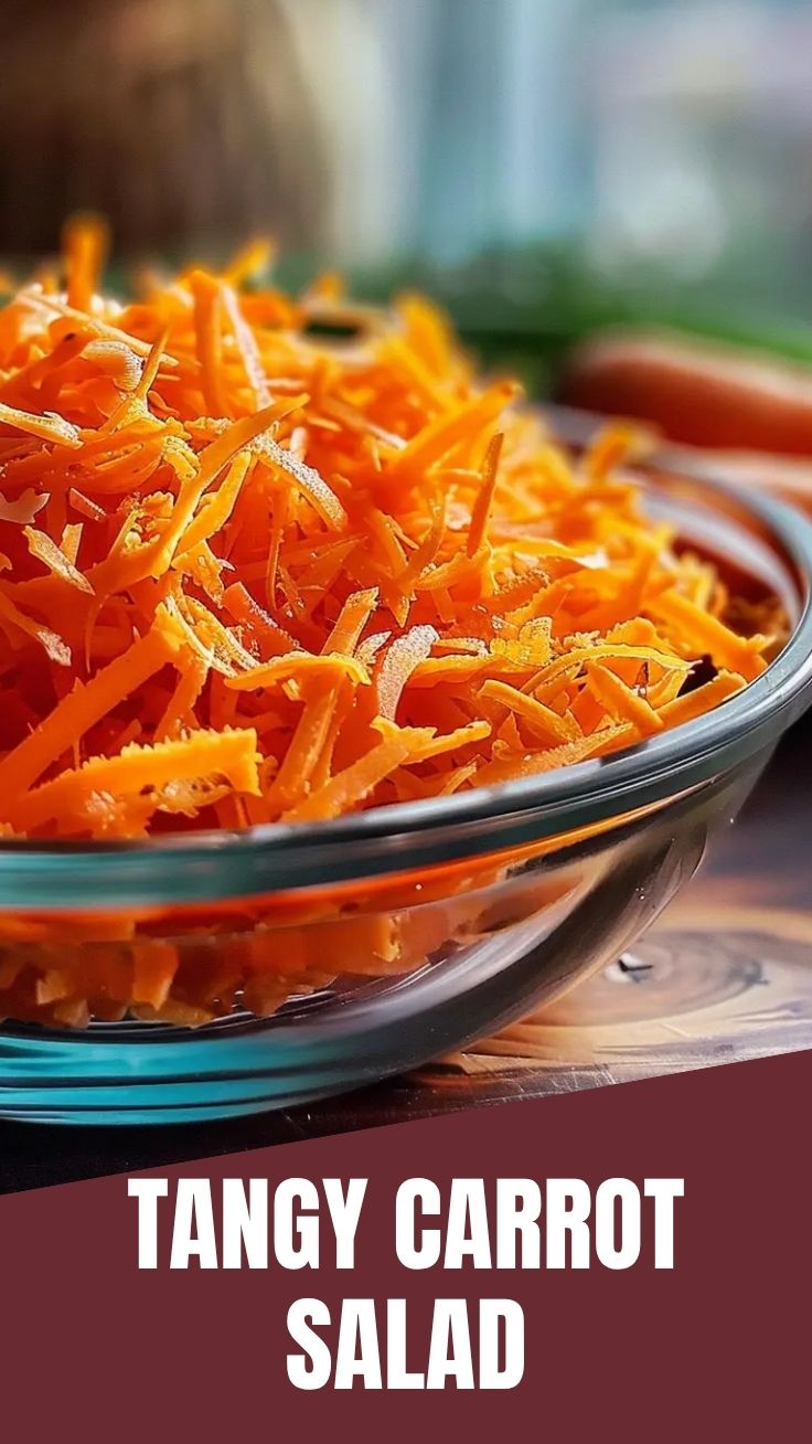 A vibrant bowl of the viral TikTok carrot salad, featuring shredded carrots and fresh herbs.