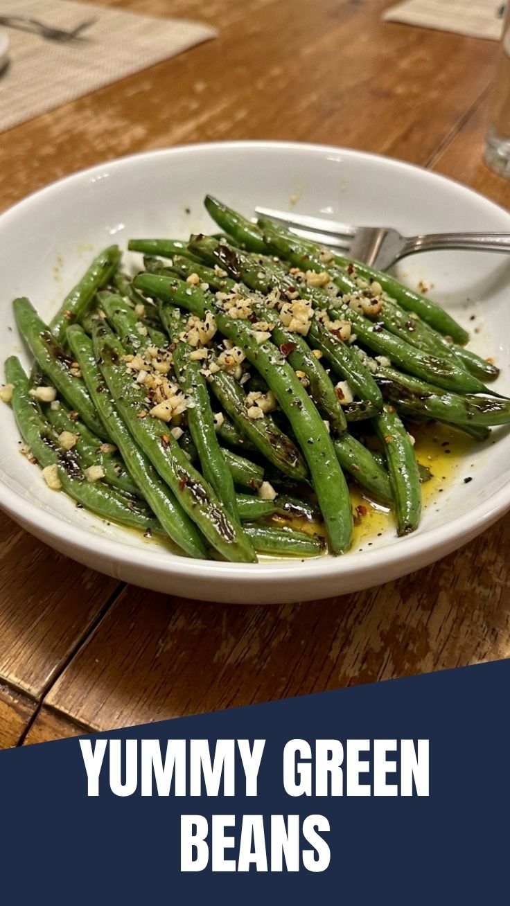 Close-up of vibrant green beans sautéed with minced garlic