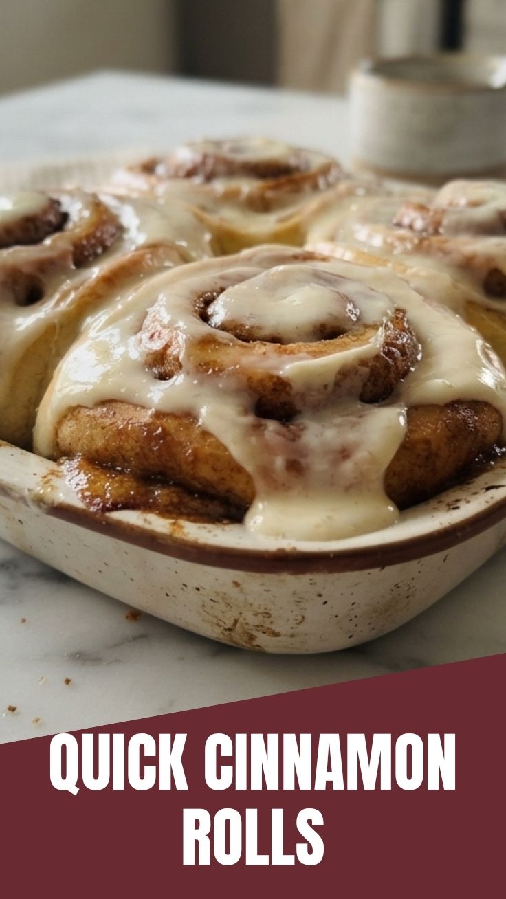 Platter of freshly baked cinnamon rolls with white icing